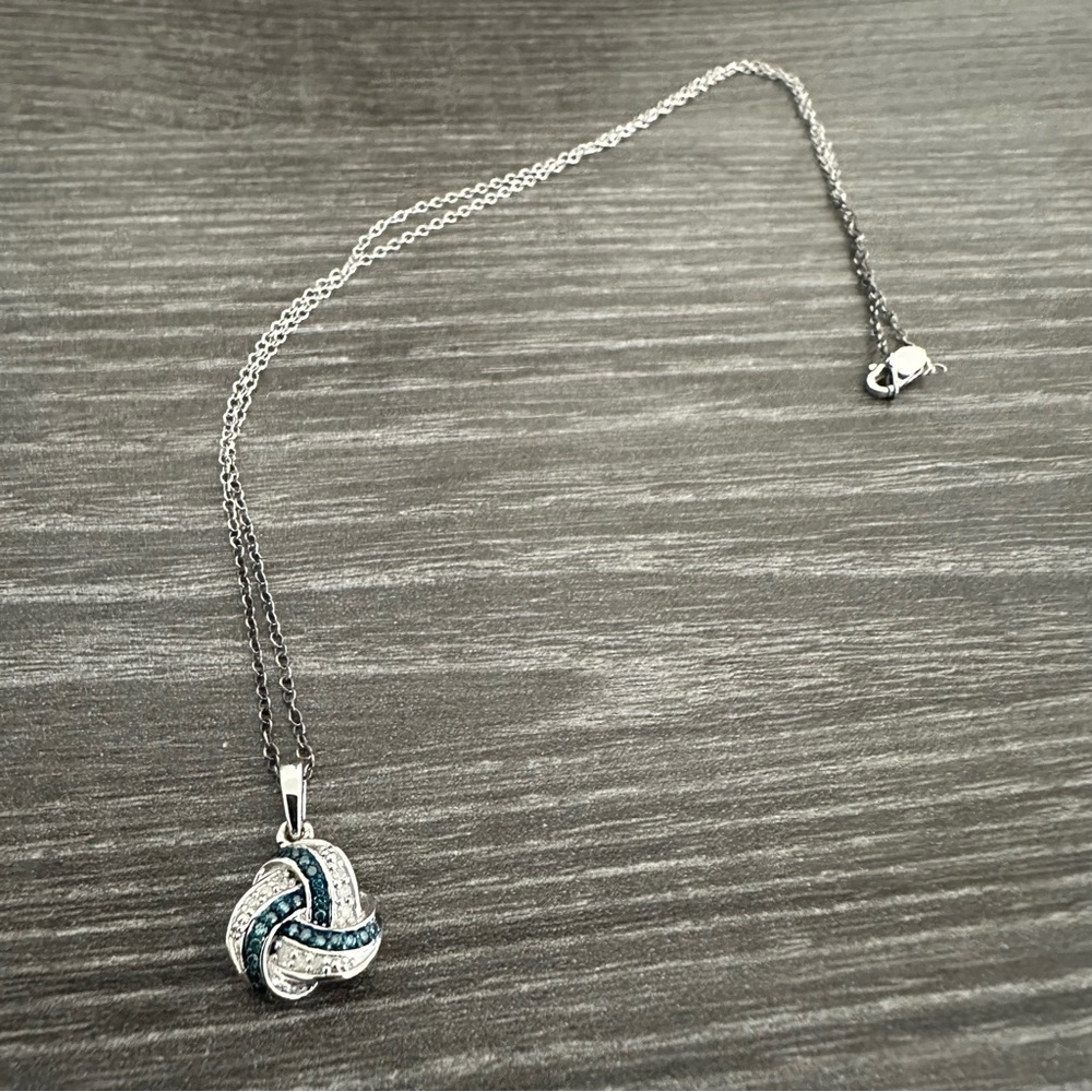 Stunning blue and white diamond love knot pendant necklace